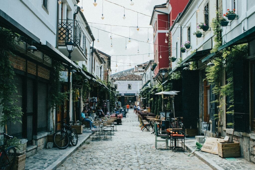 ALL European Countries With Digital Nomad Visas (2024) 1 A small street with chairs lined up in the middle at Albania.