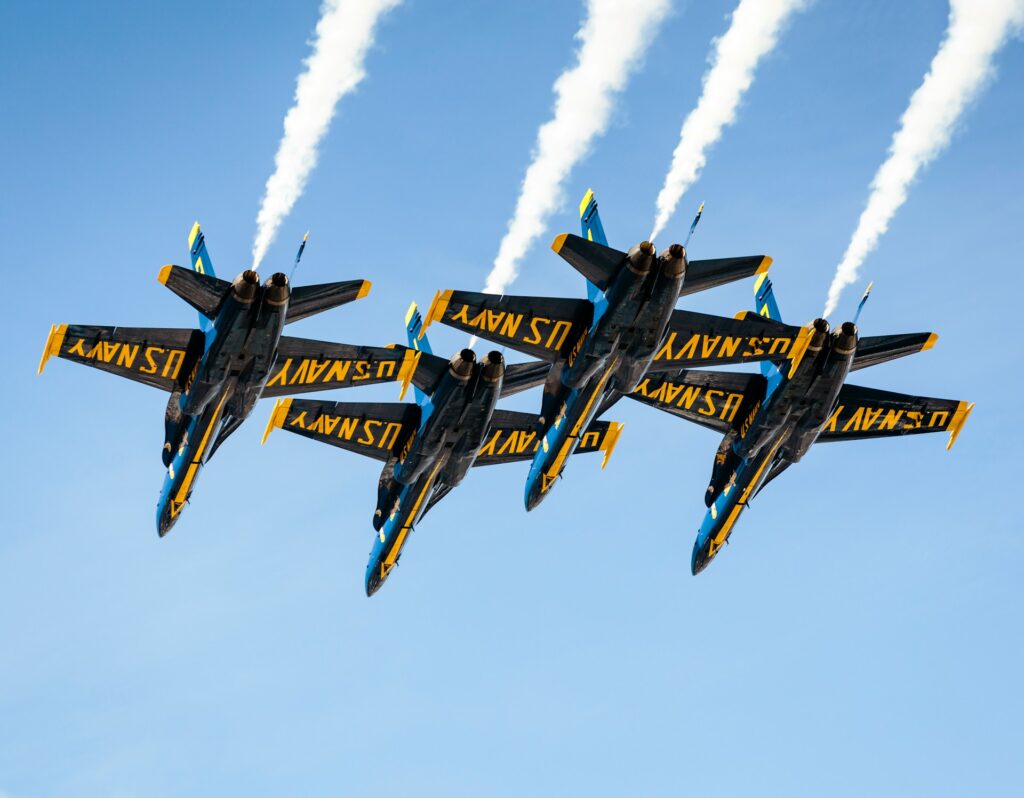 20 Reasons Not to Live in the US (2024) 16 Four black U.S. Navy jet planes flying in the sky.