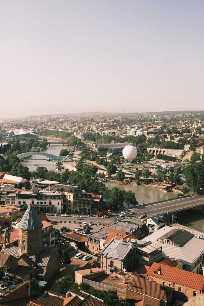 ALL European Countries With Digital Nomad Visas (2024) 8 Aerial view of city buildings along the river at Georgia.