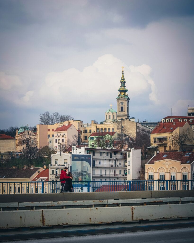ALL European Countries With Digital Nomad Visas (2024) 18 A couple walking on the streets facing the buildings in Serbia.