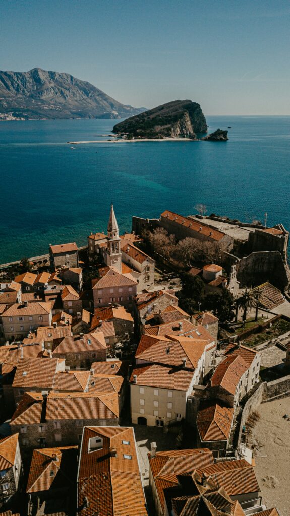 ALL European Countries With Digital Nomad Visas (2024) 15 An aerial view of the buildings with brown roof by the sea at Montenegro.
