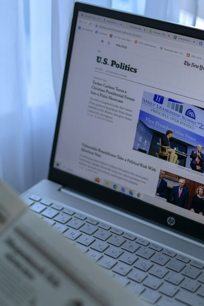 20 Reasons Not to Live in the US (2024) 12 An open laptop viewing the current news on U.S. politics.