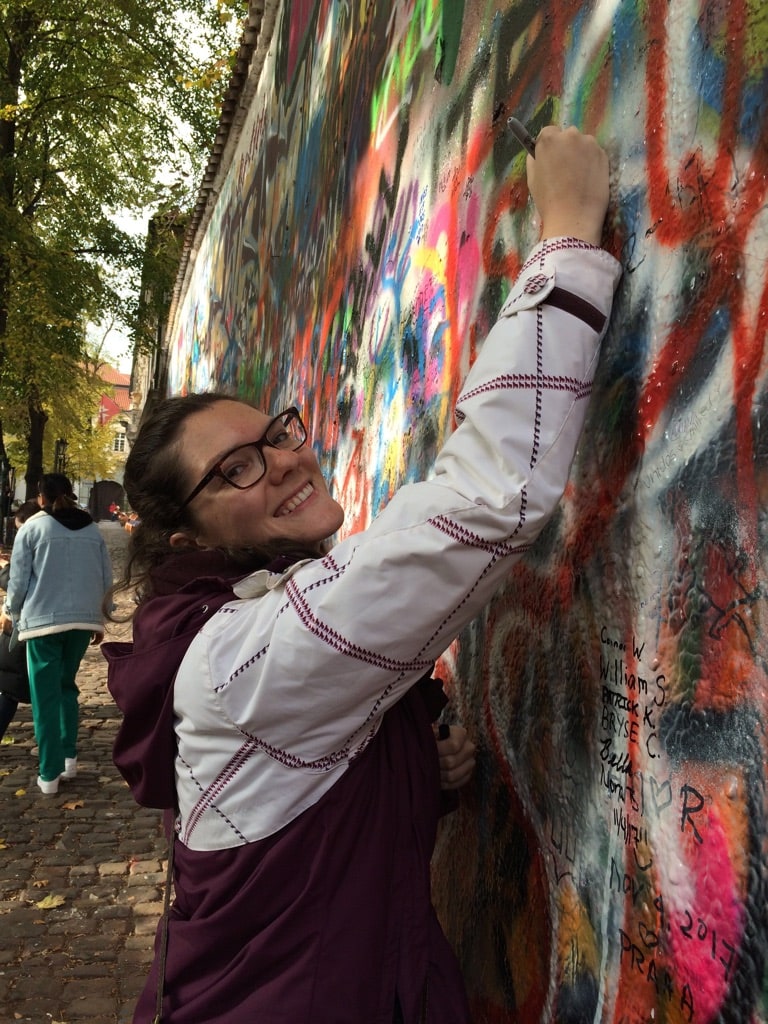 14 Top Freelance Visa Countries To Live And Work In 2024 4 A woman with glasses signing a wall in Czech Republic.