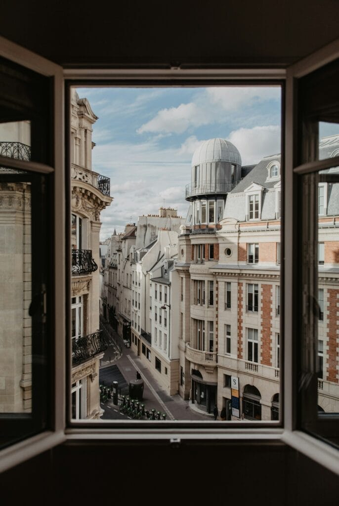 14 Top Freelance Visa Countries To Live And Work In 2024 3 A huge window with a view of the old buildings in France.