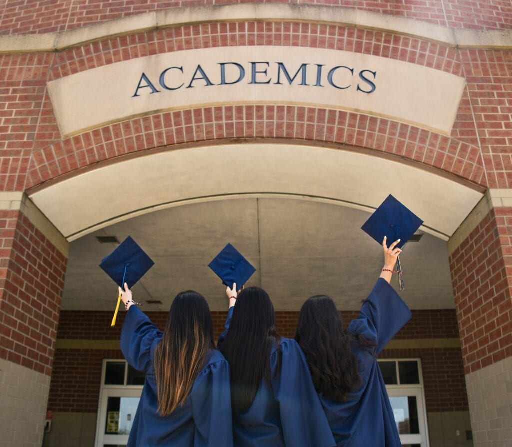 11 Reasons to Live in the US 10 Three ladies in blue graduation gown holding their hat during graduation.