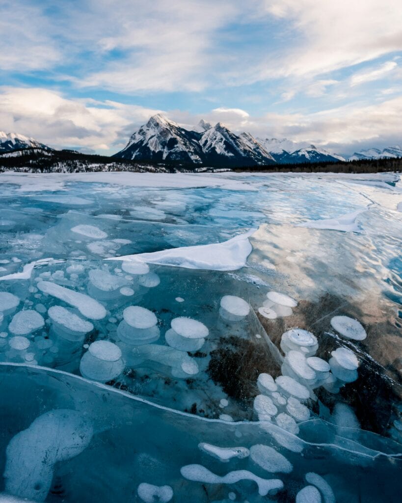 9 Must-See Natural Wonders in Canada That Are Perfect for Your Winter Getaway 6 The iconic underwater bubbles at Abraham Lake during winter.