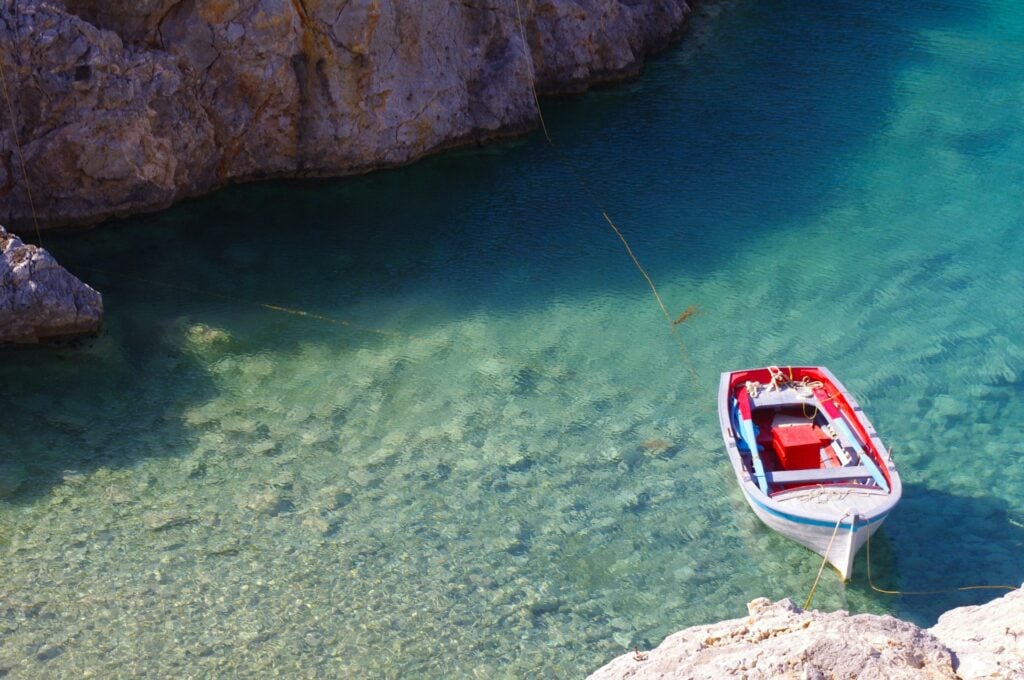 13 Countries That Will Pay You To Move There (Expat’s Picks) 9 A small boat tied on the rock in the isolated island of Antikythera in Greece.