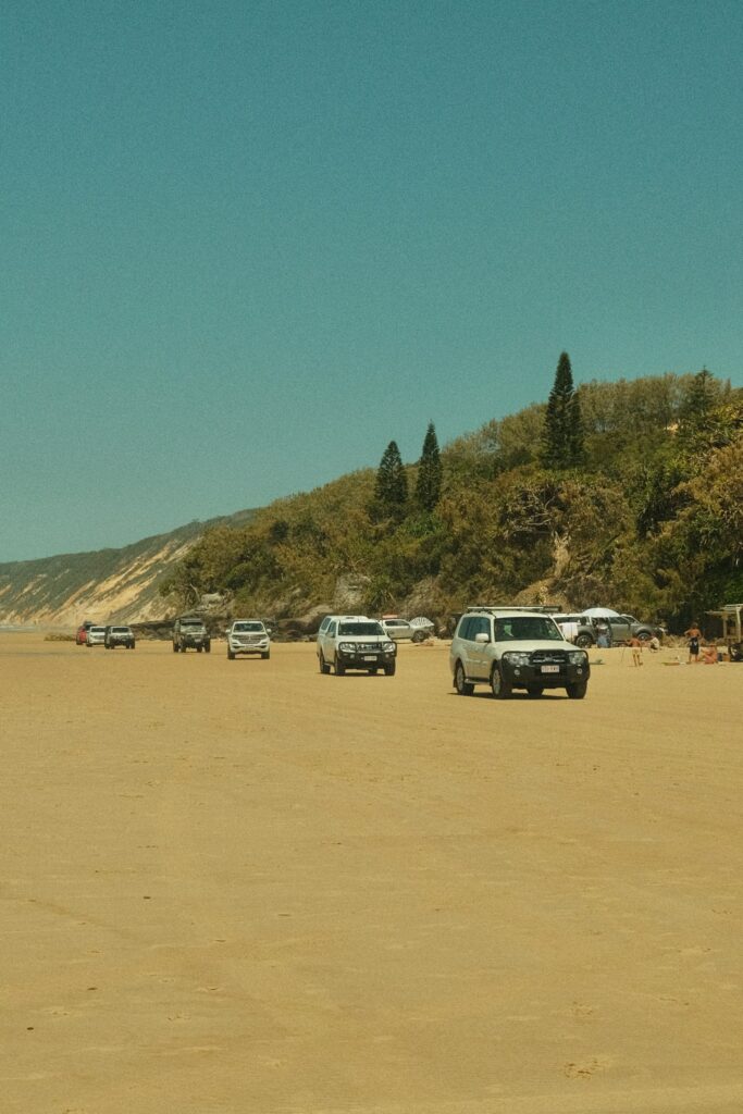 19 Reasons Not To Move To Australia In 2024 16 Cars driving by the beach in Australia.