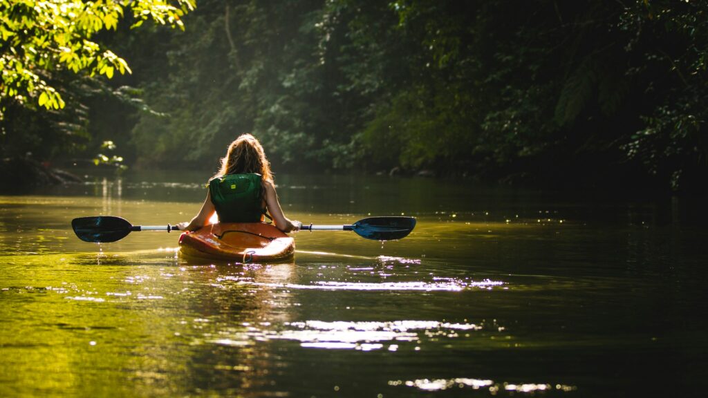 Top 17 Countries With Retirement Visas (2024 Guidelines) 1 A woman riding a kayak while passing through a river in Costa Rica.