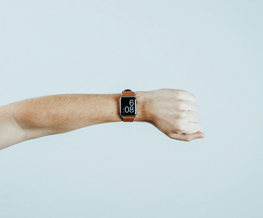 19 Reasons Not To Move To Australia In 2024 4 A hand with a smartwatch with orange strap.