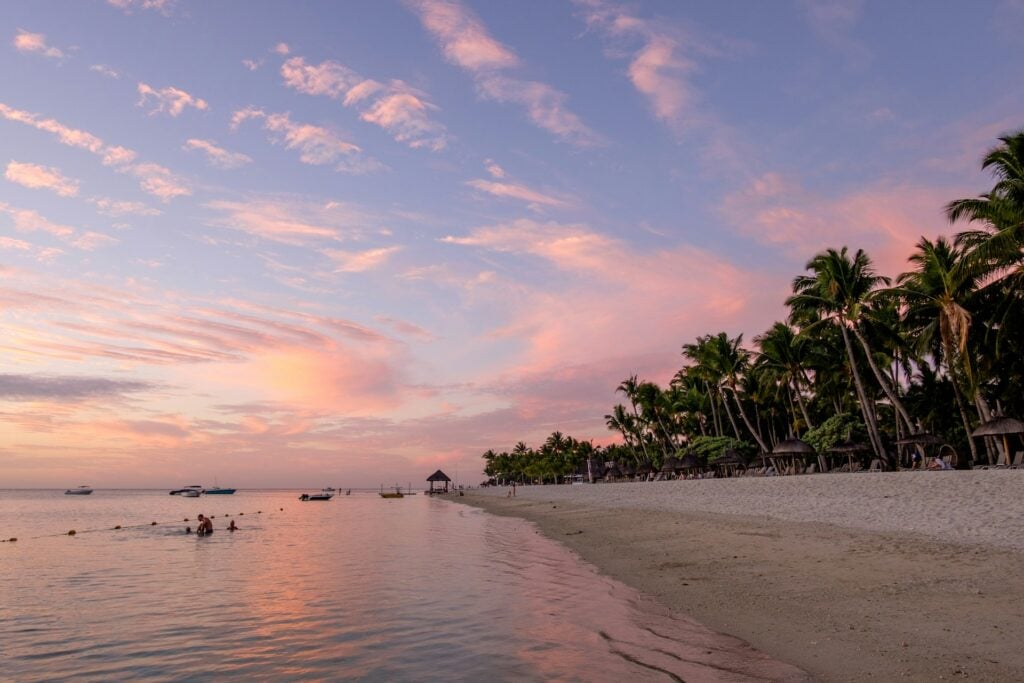 Top 17 Countries With Retirement Visas (2024 Guidelines) 16 A blue and pink sky during sunset at a beach in Mauritius.