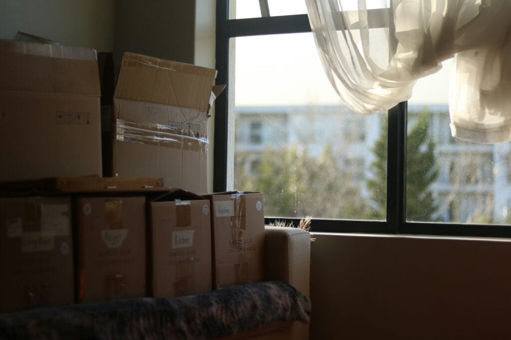 New Zealand Paying People To Move There: 2024 Guide 4 A pile of brown boxes packed before moving.