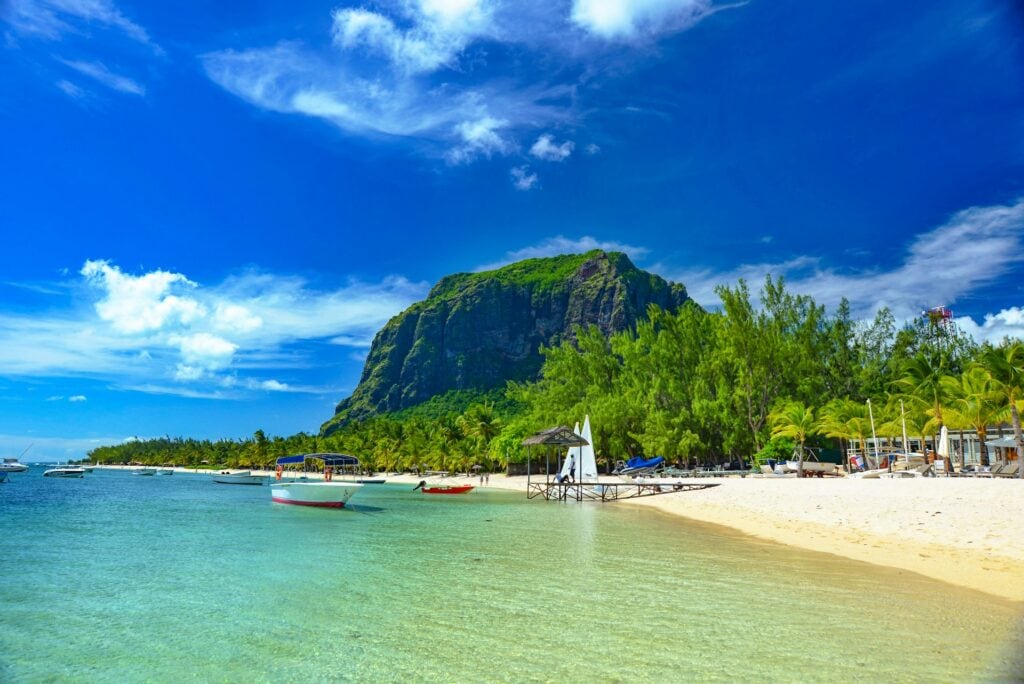 13 Countries That Will Pay You To Move There (Expat’s Picks) 11 Small boats docked near the beach with clear waters in Mautitius.