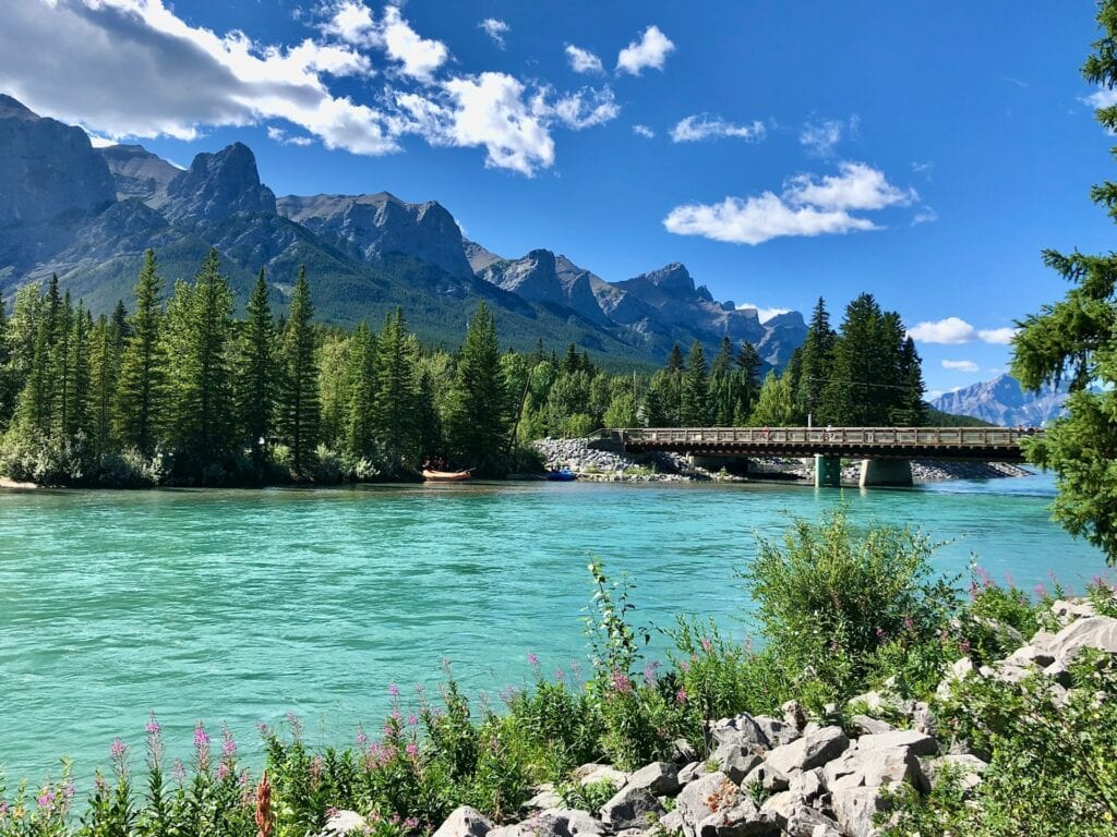 15 Best Places to Retire in Canada (From a Local Canadian!) 12 The clear blue waters of a lake in Canmore during summer.