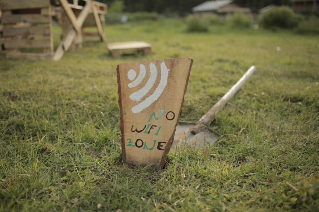 19 Reasons Not To Move To Australia In 2024 9 A wooden signage for No Wifi Zone stuck on the ground with a shovel.
