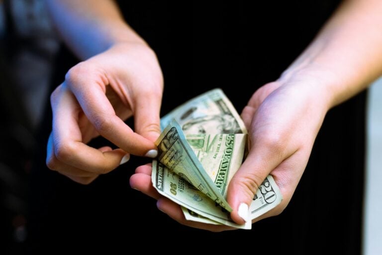 Cost of Living in Canada vs US (Complete 2024 Comparison) 6 counting money to represent the cost of living in Ottawa