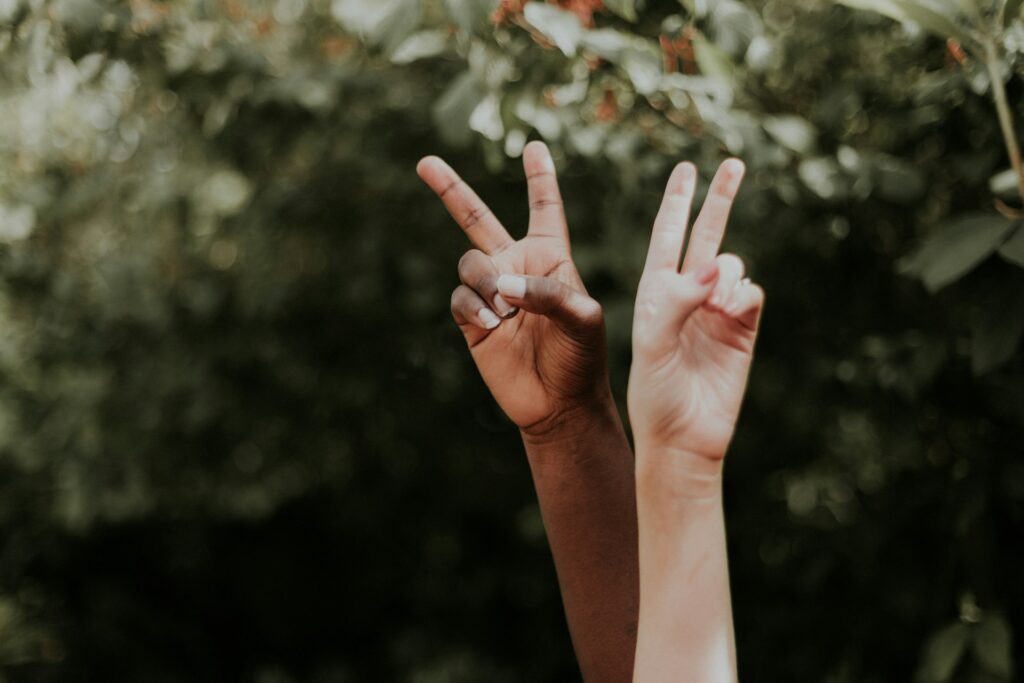 19 Reasons Not To Move To Australia In 2024 11 A black and white hand together showing the peace sign to fight racism.