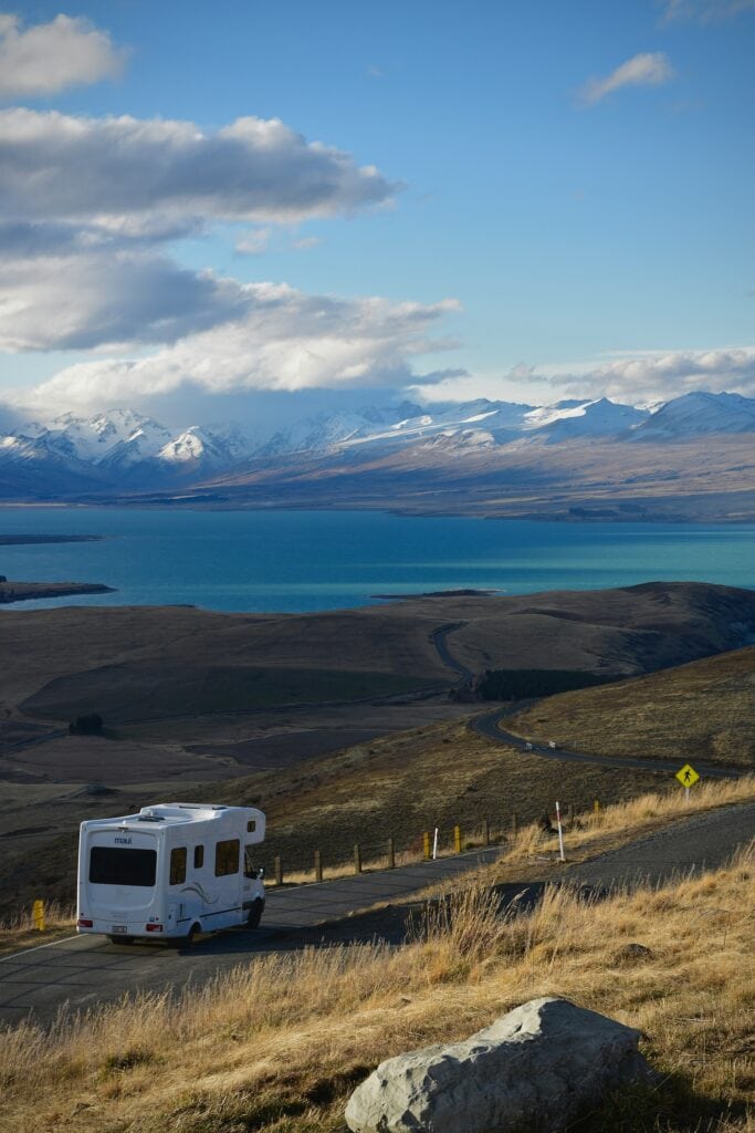 New Zealand Paying People To Move There: 2024 Guide 7 A small camper van on the road in New Zealand.