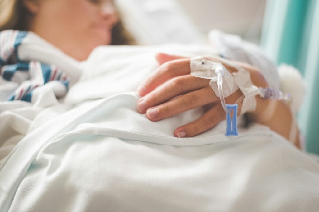 Cost of Living in Canada vs US (Complete 2024 Comparison) 3 A woman in a hospital with a IV line.