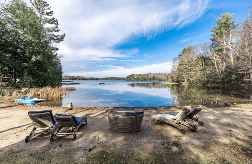 20 Top Airbnb Cottages in Muskoka for an Epic Getaway 58 a few sun loungers lookin gout to the lake on a cool fall day
