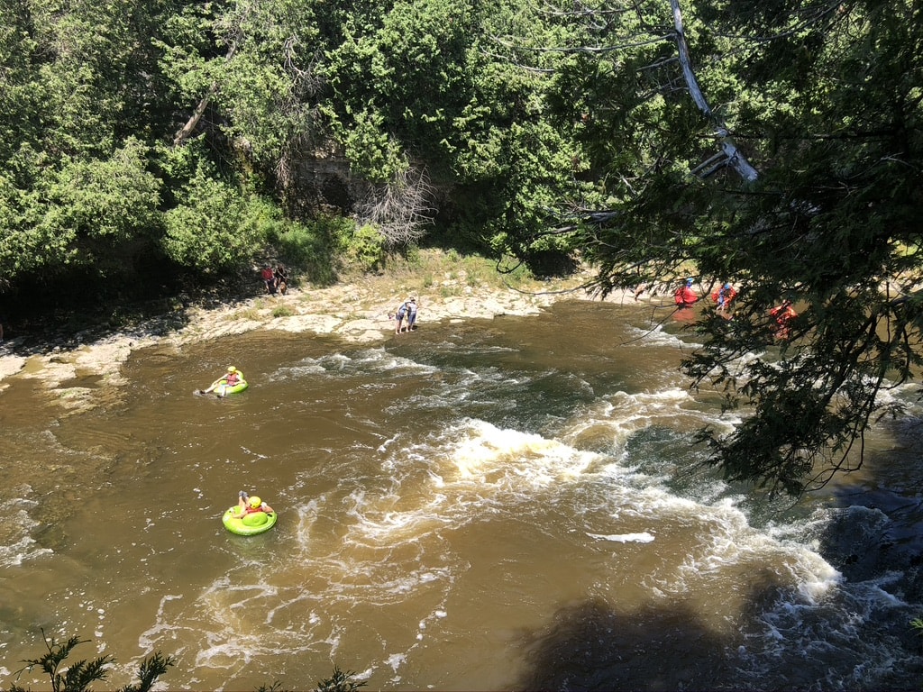 Best Time to Visit Toronto (A Month-By-Month Guide) 7 People tubing down the rapid at Elora Gorge during the peak of summer.