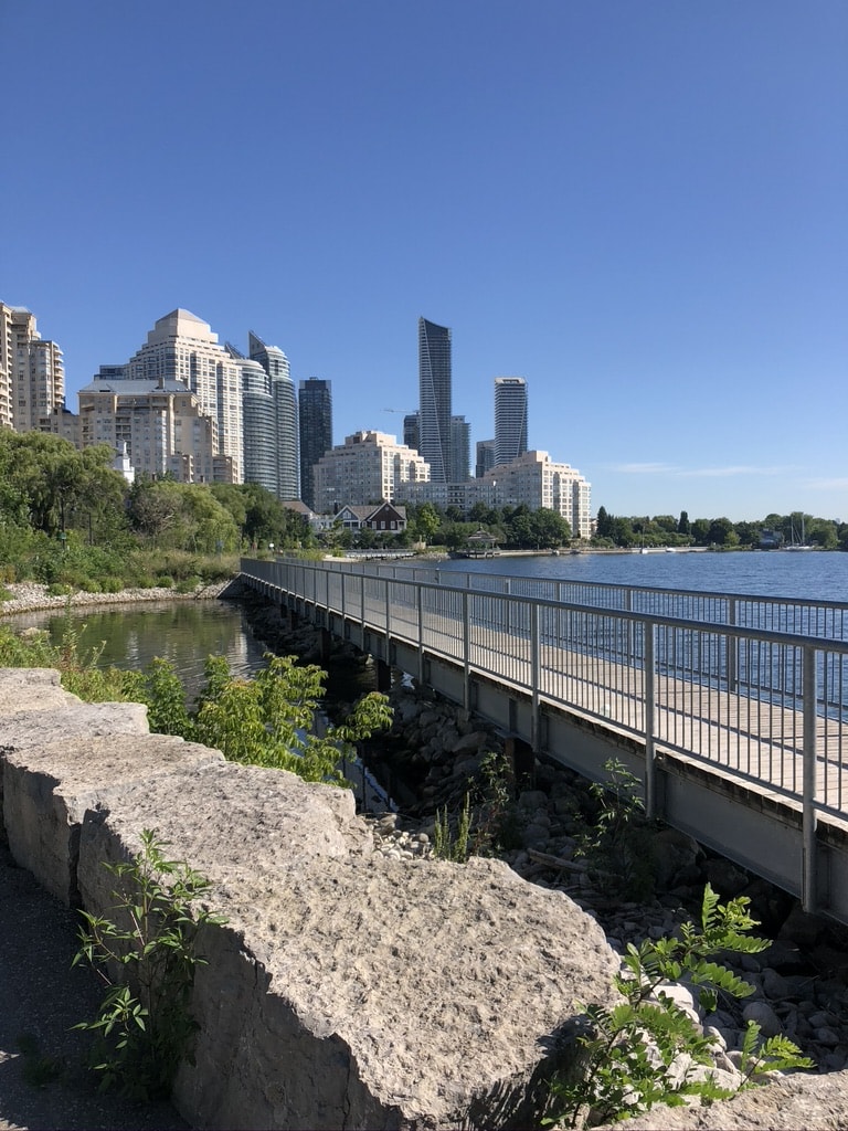 Best Time to Visit Toronto (A Month-By-Month Guide) 10 The view of skyscrapers across the water while walking along Lake Ontario trail in Toronto