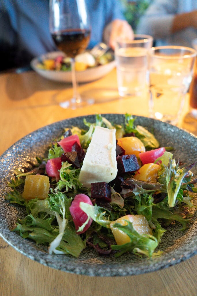 My 4 Day Charlevoix Itinerary to Recharge in Quebec 15 Close-up of a fresh salad topped with goat cheese, diced beets, and mixed greens served at Le Germain restaurant. Farm-to-table meals like this are part of the region’s culinary charm.