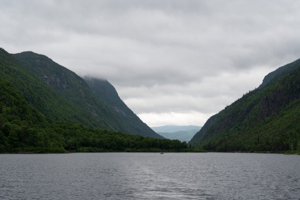 My 4 Day Charlevoix Itinerary to Recharge in Quebec 12 Misty fjord-like river gorge surrounded by steep green cliffs on a cloudy day. Taking a calm river cruise through Hautes-Gorges is a memorable way to see Quebec’s wild side.